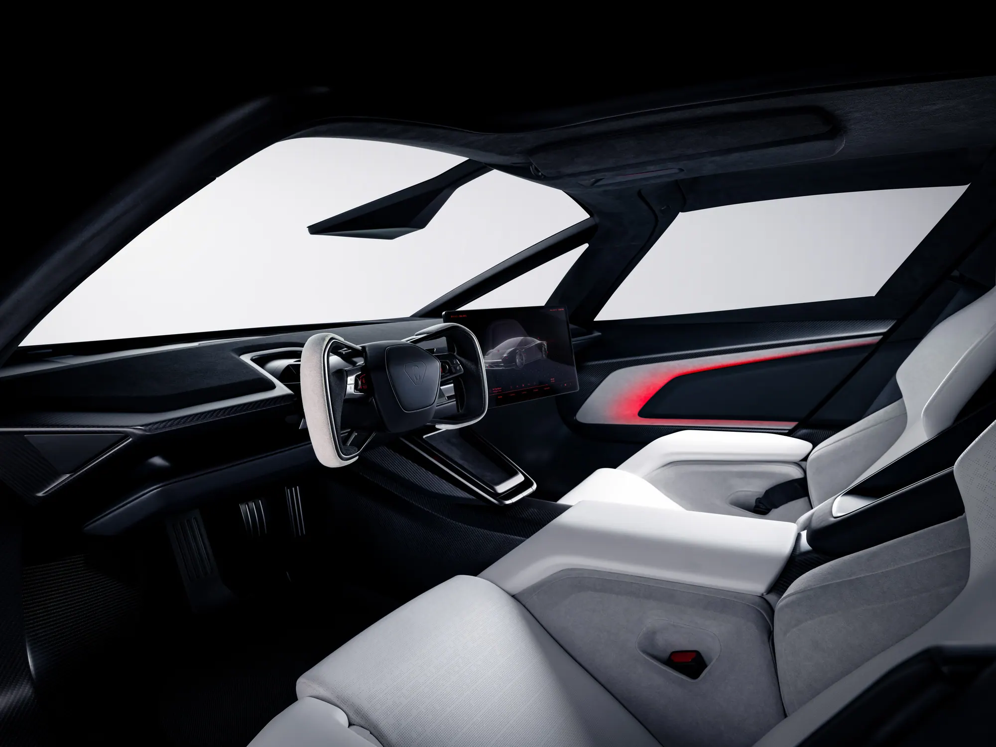 Interior of the Roadster, with white seats, a light-coloured yoke, a centre screen showing the car, and a red light along the door.