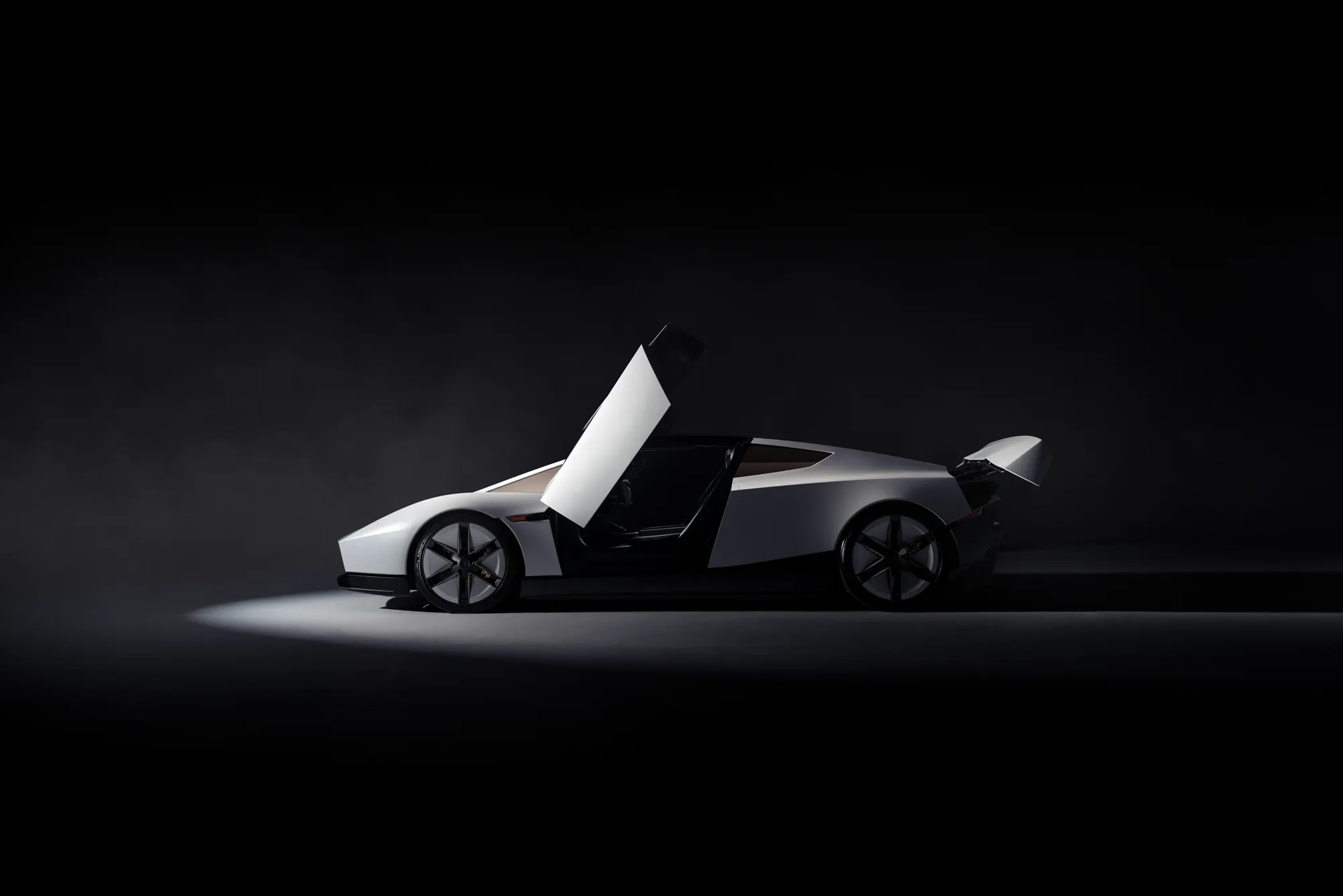 Side view of the white Roadster with the door and the rear wing raised.